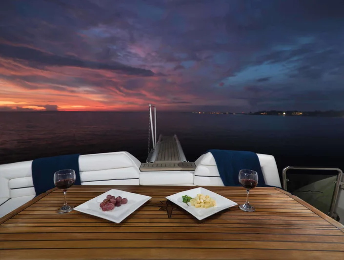 Aicon Fly aft deck dining table at sunset