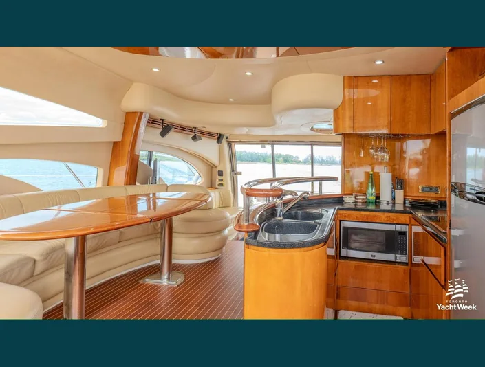 Azimut 62 wood galley and cream dining lounge