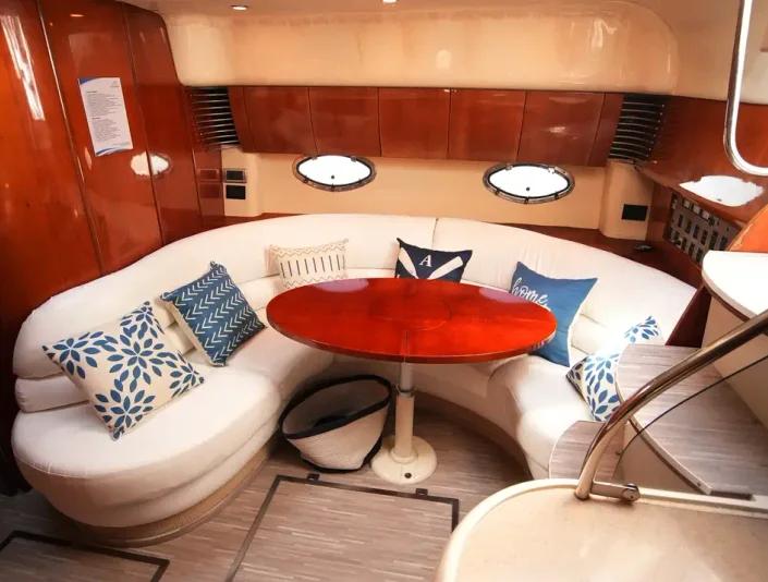 Fairline 43 interior lounge with curved seating and wood finishes