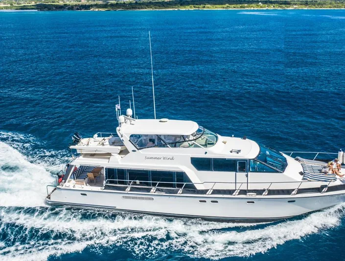 Pacific 72 Summer Wind cruising with blue and white bow sunpads