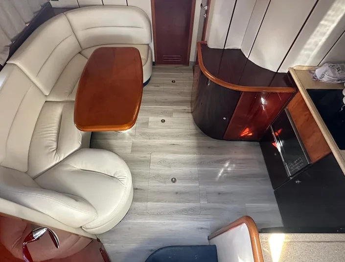 Princess 42 interior lounge with curved seating and wood finishes