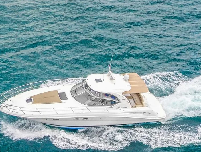 Sea Ray 42 cruising with a tan bow sunpad and sheltered cockpit