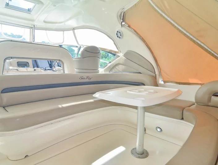 Sea Ray 42 shaded cockpit with curved cream seating and a white table