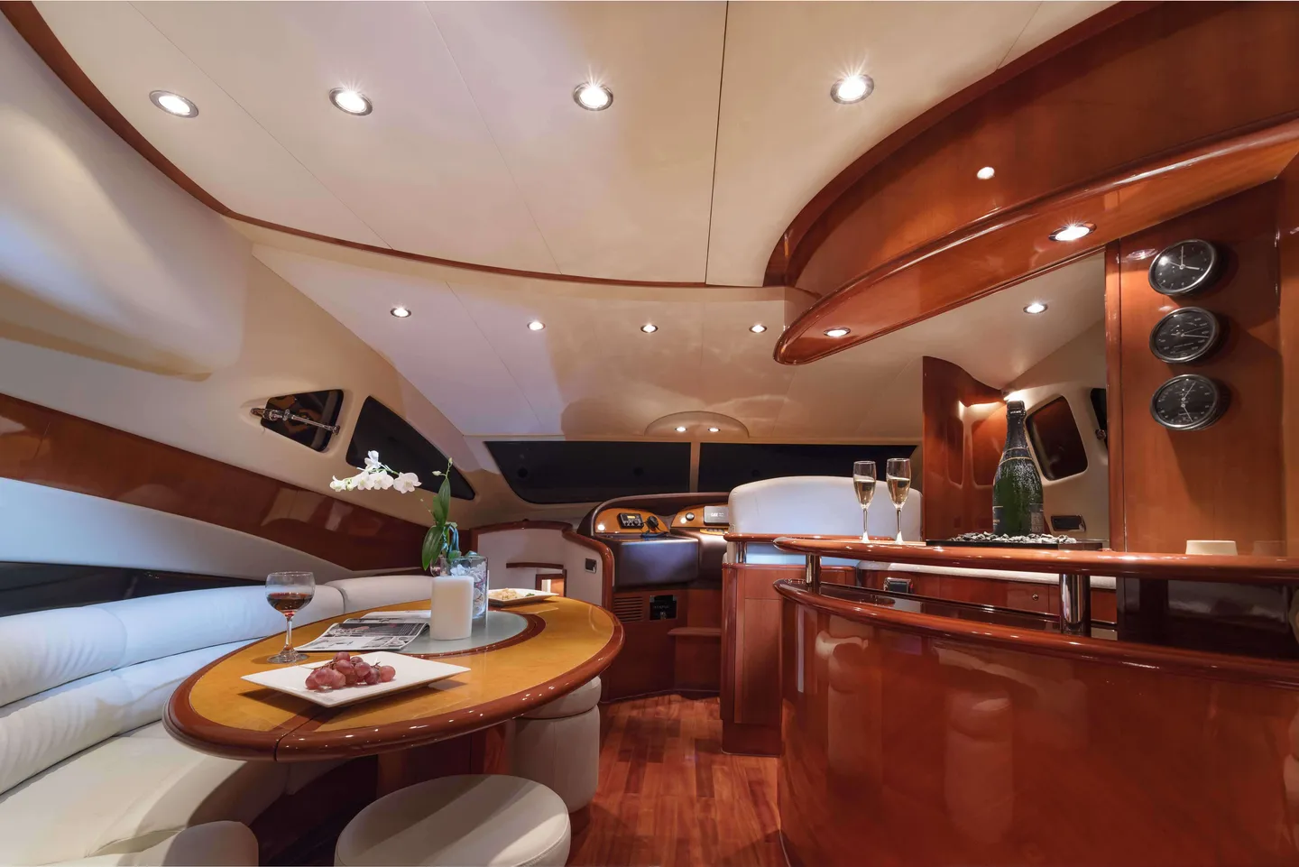 Spacious wood-finished salon with cream sofas
