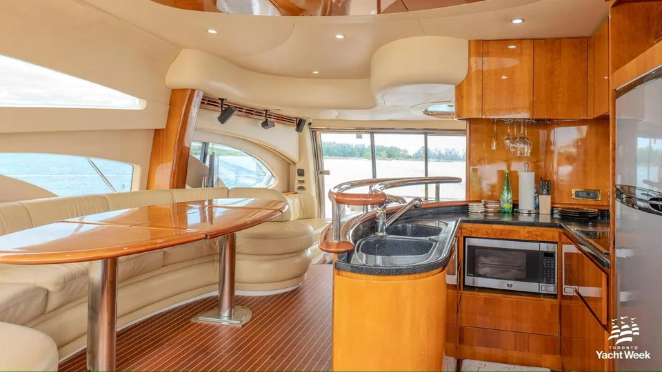 Azimut 62 wood galley and cream dining lounge