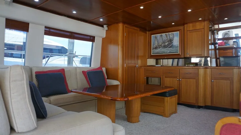 Pacific 72 wood-paneled salon with cream sofa and polished table