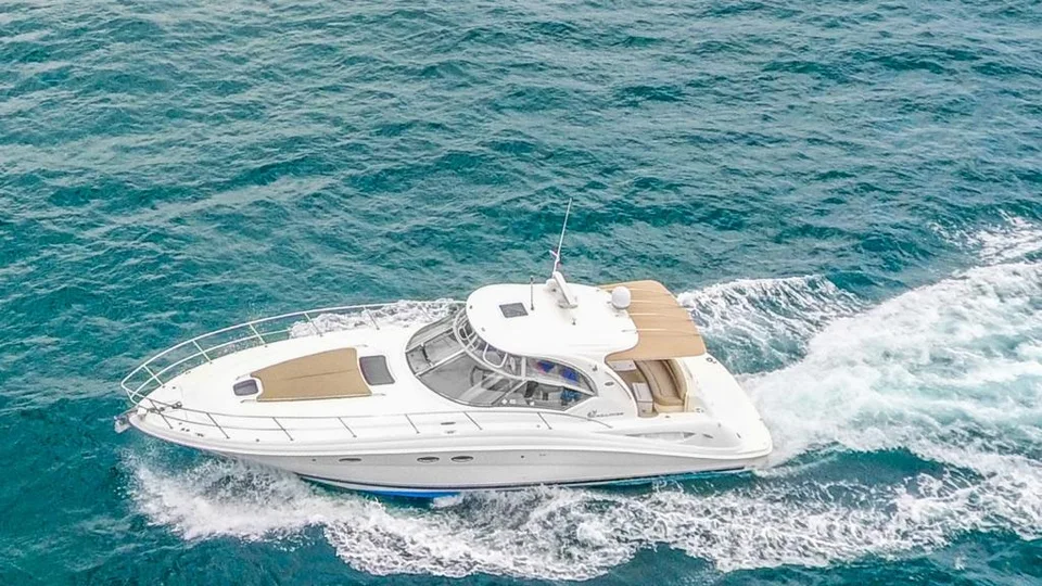 Sea Ray 42 cruising with a tan bow sunpad and sheltered cockpit