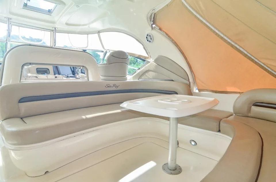 Sea Ray 42 shaded cockpit with curved cream seating and a white table