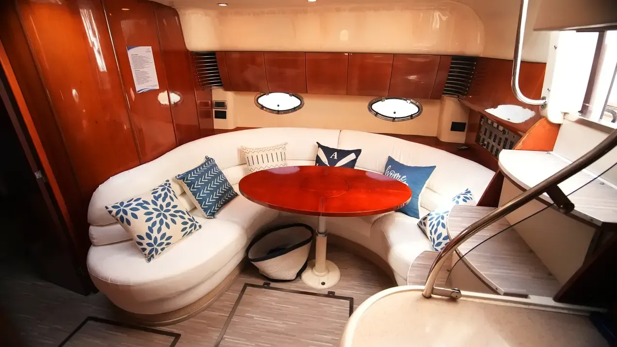 Fairline 43 interior lounge with curved seating and wood finishes
